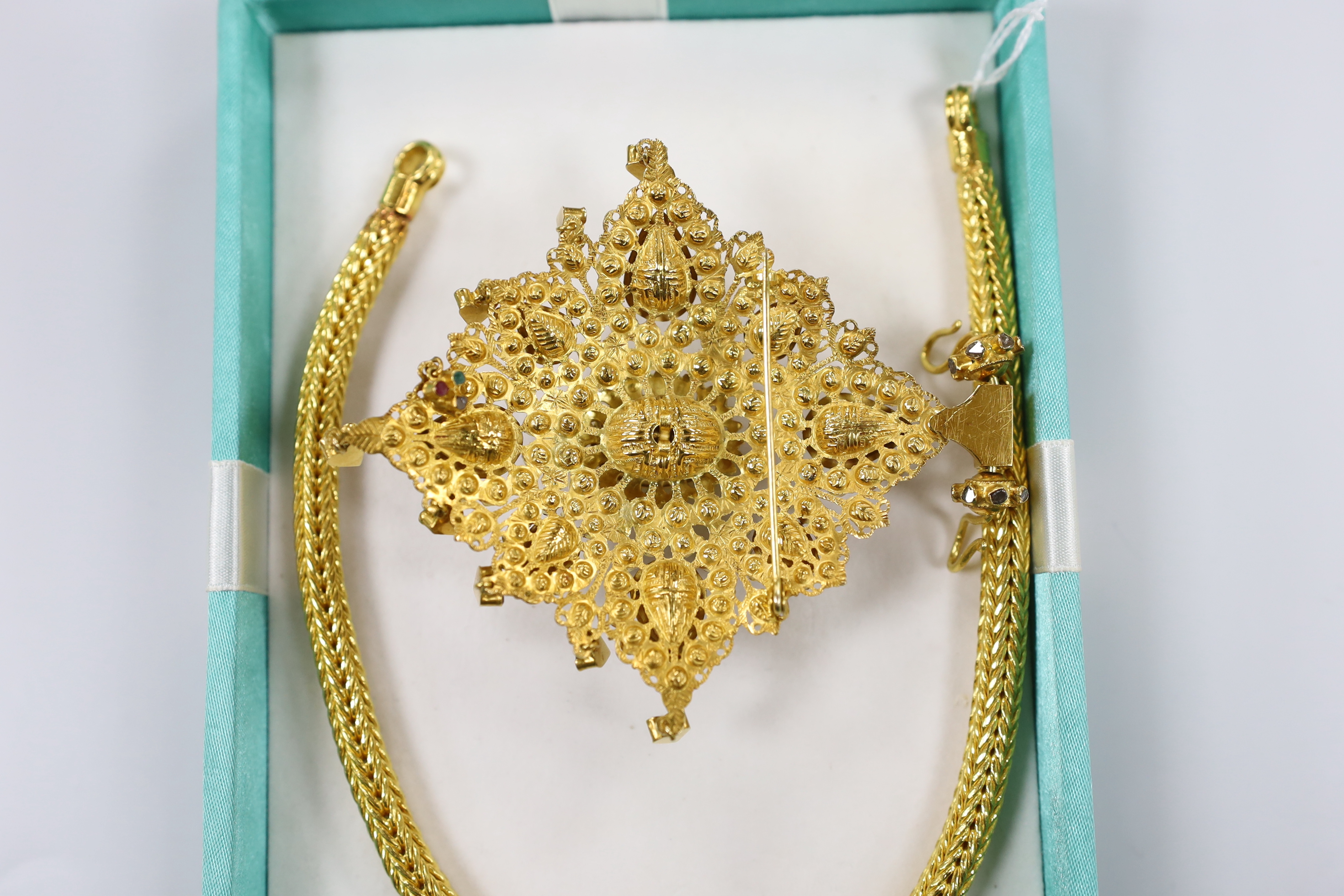 A 20th century Thai high grade yellow metal, ruby, emerald and rose cut diamond cluster set drop pendant, 95mm, on a high grade yellow metal interwoven chain, 34.5cm, gross 269.8 grams, with two spare clasp loops.